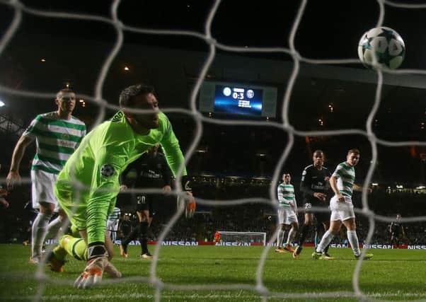 Craig Gordon of Celtic looks on in despair as Mikael Lustig scores an own goal during the Champions League  match against PSG.