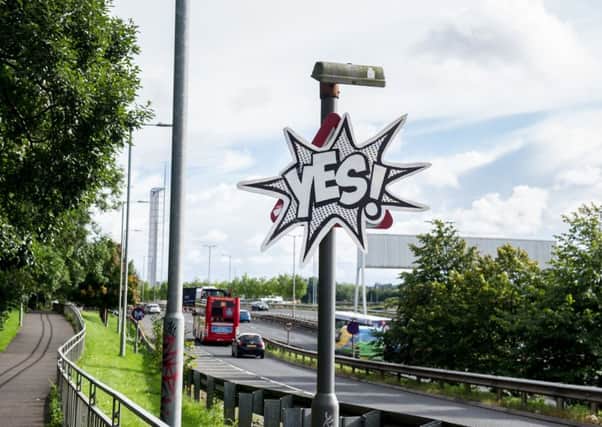 A road traffic warning signs on the slip road onto the Clydeside Expressway has been covered up by a Yes sign. Picture: John Devlin