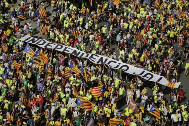 Catalans hold a banner proclaiming 'Independence now' as they gather for a rally to show support for the right to vote in a controversial referendum that has been banned by Spain. Picture: AP/Emilio Morenatti