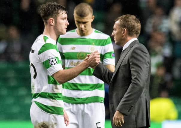 Brendan Rodgers, right, insists Celtic's belief won't be punctured by their 5-0 defeat by PSG. Picture: SNS