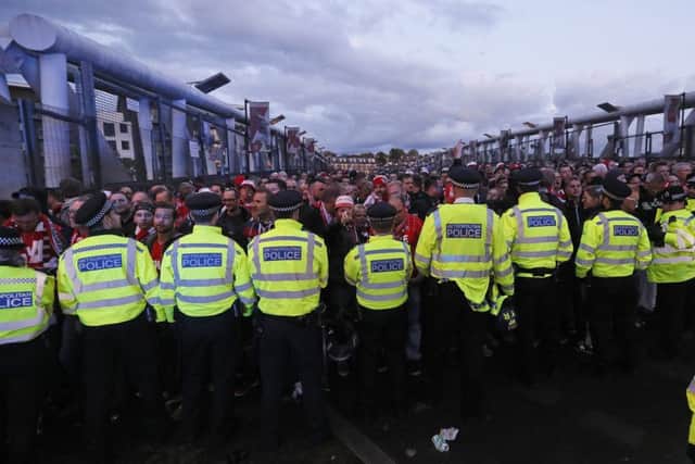 Police forces block FC Koln supporters outside the Emirates stadium. Picture: AP Photo/Kirsty Wigglesworth