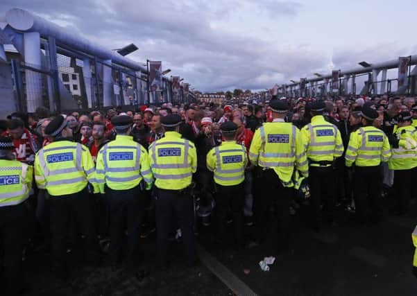 Police forces block FC Koln supporters outside the Emirates stadium. Picture: AP Photo/Kirsty Wigglesworth