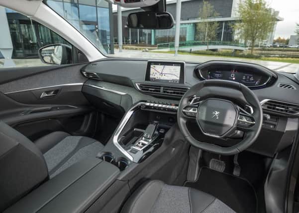 The new Peugeot 3008 cabin features the i-cockpit pioneered in the 308 hatch, behind a cut-off steering wheel.