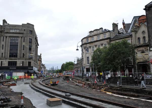 This scene at Edinburgh's busy West End gives an indication of the disruption to transport and businesses caused by the laying of tram tracks. 
Photograph: Kate Chandler