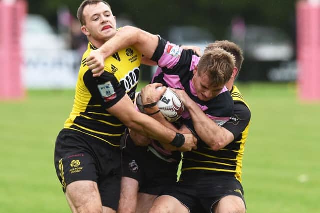 Melrose scrum-half Murdo McAndrew, left, grapples with Ayrs Scott Lyle at Millbrae. Photograph: Paul Devlin/SNS