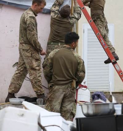 Assault Engineers from 40 Commando Royal Marines help fix up Alvin and Dorothy Nibbs' house in Road Town, Tortola. Picture: LPhot Joel Rouse/Royal Navy/MOD/Crown copyright/PA Wire