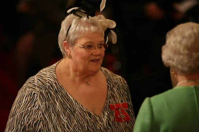 Penelope Jones as she receives her MBE from Queen Elizabeth. Picture: PA