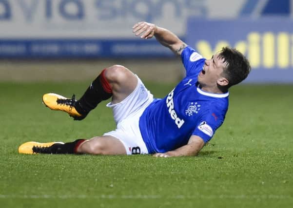 Ryan Jack feels the effects of a challenge from Ryan Edwards. Picture: SNS