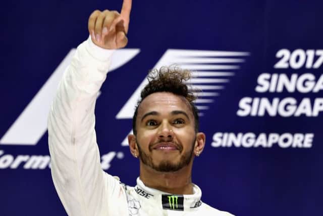 Britains Lewis Hamilton celebrates on the podium after his victory in the Singapore Grand Prix. Picture: Mark Thompson/Getty Images