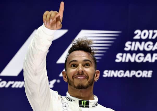 Britains Lewis Hamilton celebrates on the podium after his victory in the Singapore Grand Prix. Picture: Mark Thompson/Getty Images