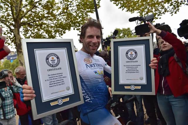 British cyclist Mark Beaumont  holds a Guinness World Records certificates in Paris on September 18, 2017 after he completed his journey around the world in 78 days. Picture: Getty Images