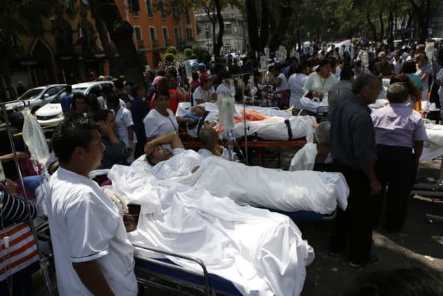 Patients lie on their hospital beds after being evacuated following the earthquake in Mexico City. Picture: AP