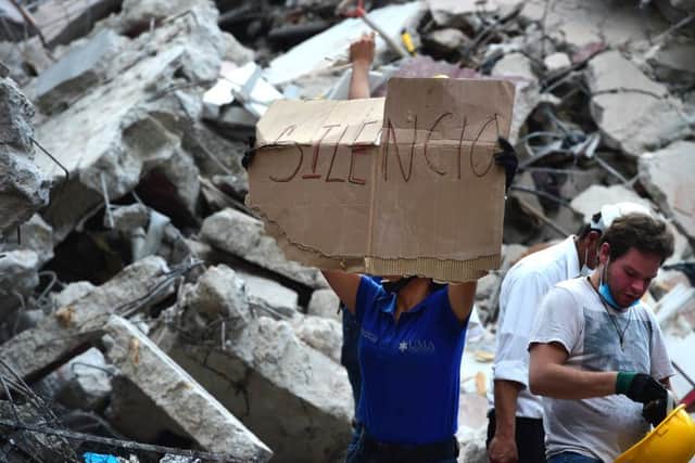 Rescuers searching for survivors buried under the rubble ask for silence in Mexico City. Picture: AFP/Getty Images