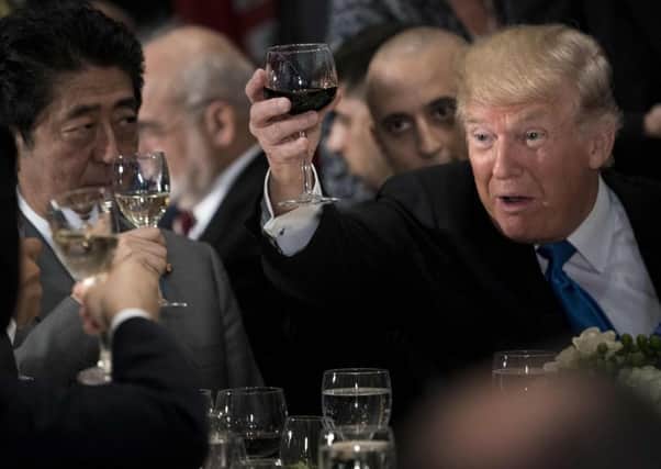 US President Donald Trump raises his glass to a toast by UN Secretary-General Antonio Guterres. Picture: AFP/Getty Images
