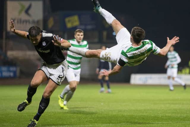 Dundee's Darren O'Dea challenges Celtic's Anthony Ralston  during the Betfred Cup quarter-final at Dens Park. Picture: Jeff Holmes/PA Wire