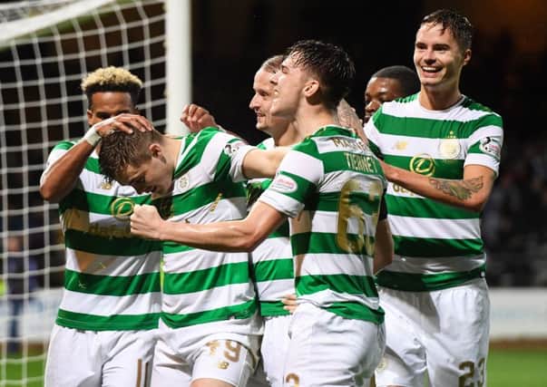 James Forrest celebrates with his team-mates after doubling his side's lead. Picture: SNS