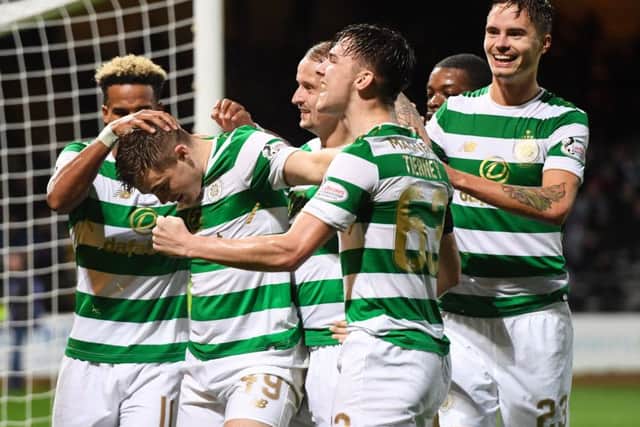 James Forrest celebrates with his team-mates after doubling his side's lead. Picture: SNS