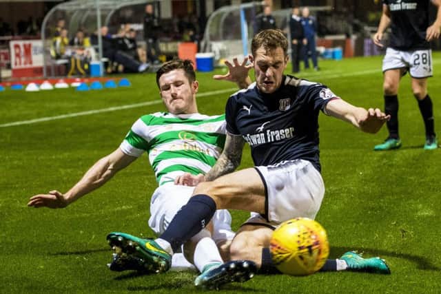 Celtic's Anthony Ralston and Dundee's Kevin Holt battle for possession. Picture: SNS