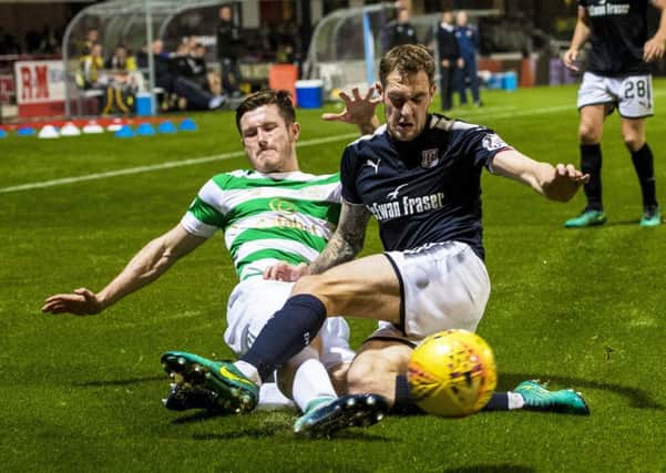 Celtic's Anthony Ralston and Dundee's Kevin Holt battle for possession. Picture: SNS