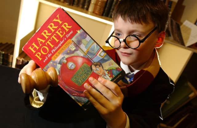 Harry Potter fan Ross Millican holds a rare first edition of Harry Potter and the Philosopher's Stone. Picture: Julie Bull/TSPL