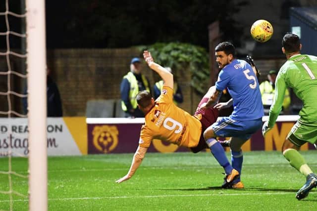 Louis Moult, back to goal, scores Motherwells opener against Aberdeen last night with an overhead kick. Picture: SNS.