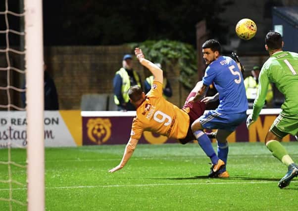 Louis Moult, back to goal, scores Motherwells opener against Aberdeen last night with an overhead kick. Picture: SNS.