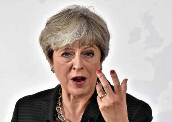 British Prime Minister Theresa May gestures  as she delivers a speech in Florence aimed at unlocking Brexit talks. Pic: Getty Images