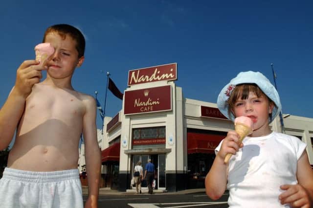 Scott McNamara and Toni McNamara of Prestwick enjoy ice cream from Nardini's in Largs.
 Picture: Robert Perry/Scotland on Sunday.