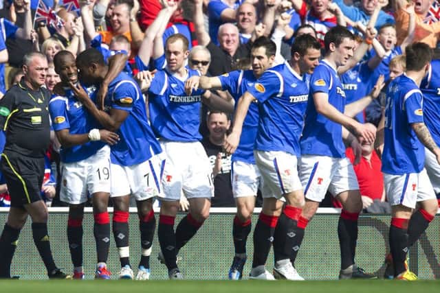 Sone Aluko (left) is mobbed by his Rangers team-mates after scoring the opener against Celtic in a 3-2 win in 2012. Picture: SNS