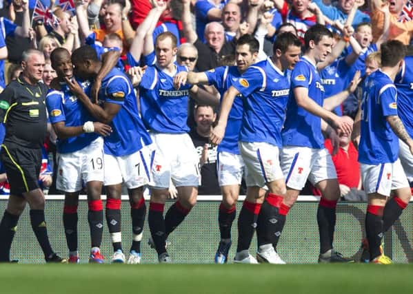Sone Aluko (left) is mobbed by his Rangers team-mates after scoring the opener against Celtic in a 3-2 win in 2012. Picture: SNS