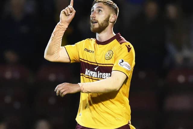 Motherwell's Louis Moult celebrates scoring the third goal against Aberdeen. Picture: Rob Casey/SNS