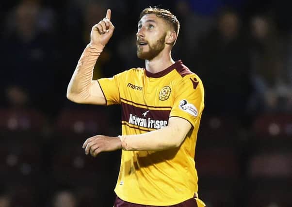 Motherwell's Louis Moult celebrates scoring the third goal against Aberdeen. Picture: Rob Casey/SNS