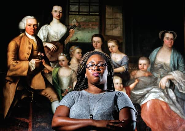 Marenka Thompson-Odlum who is originally from St Lucia and is doing a PHD on slave connections stands in front of a painting of the Glassford family. Picture: John Devlin