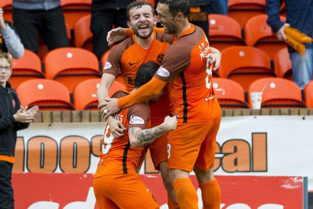 Dundee United's James Keatings (left) celebrates his opening goal with Paul McMullan (centre) and Scott McDonald. Picture: SNS/Paul Devlin