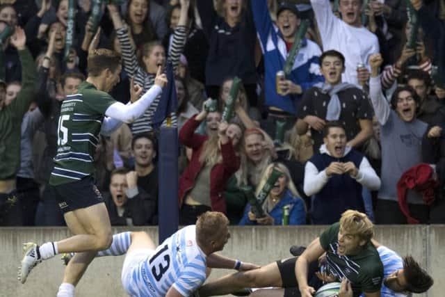 Delight shows on the faces of both the fans and Edinburghs Ben Rose as he goes over to score.  Photograph: Ross Parker/SNS