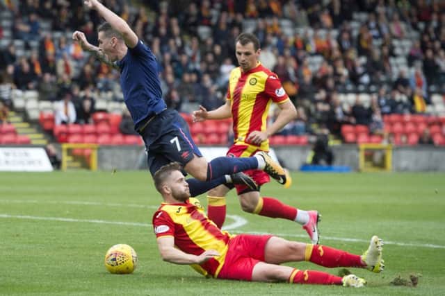 Hearts Jamie Walker goes down under Jordan Turnbulls sliding tackle, but no penalty was given. Picture: SNS.