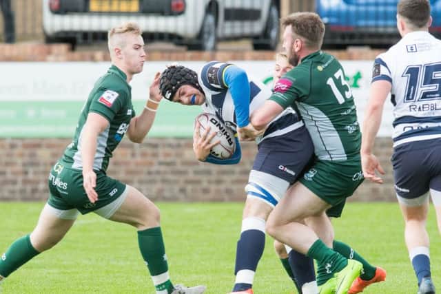 Lee Armstrong, scorer of Hawicks solitary try, holds on to Heriots flanker Jack McLean. Picture: Ian Georgeson