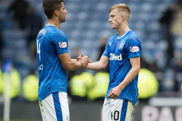 Fabio Cardoso and Ross McCrorie console each other at Ibrox. Picture: SNS.
