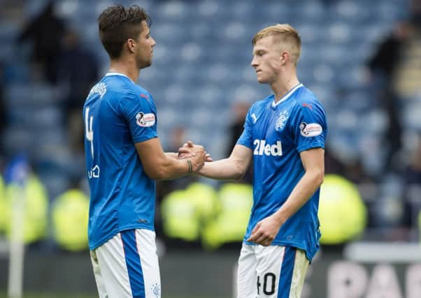 Fabio Cardoso and Ross McCrorie console each other at Ibrox. Picture: SNS.
