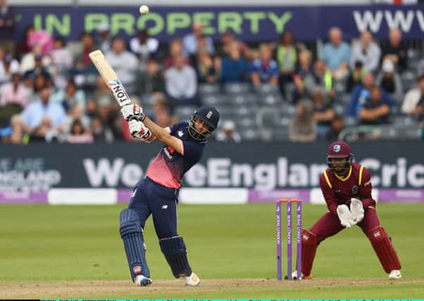 Moeen Ali hits out on his way to making 102 as West Indies wicketkeeper Shai Hope looks on. Picture: Getty