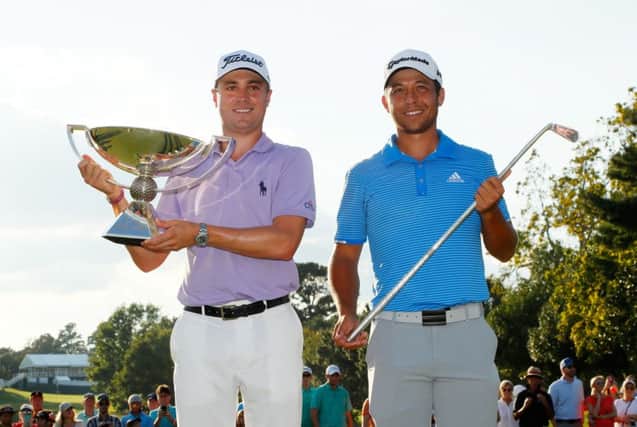 Justin Thomas and Xander Schauffle show off their respective trophies at the end of the Tour Championship in Atlanta. Picture: Getty Images