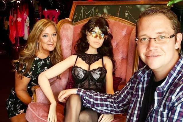 Tracey Whitmore and son Christopher with Samantha the sex robot at Vibez Adult Boutique. Picture: SWNS