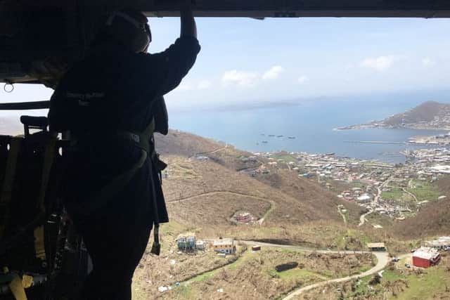 Patel looks out from a Merlin MK 3 helicopter at the damage caused by Hurricane Maria in the British Virgin Islands