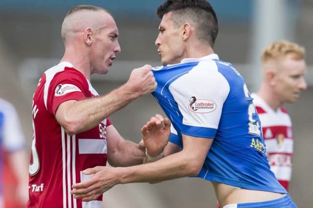 Darian MacKinnon gets involved with St Johnstone striker Graham Cummings. Picture: SNS Group