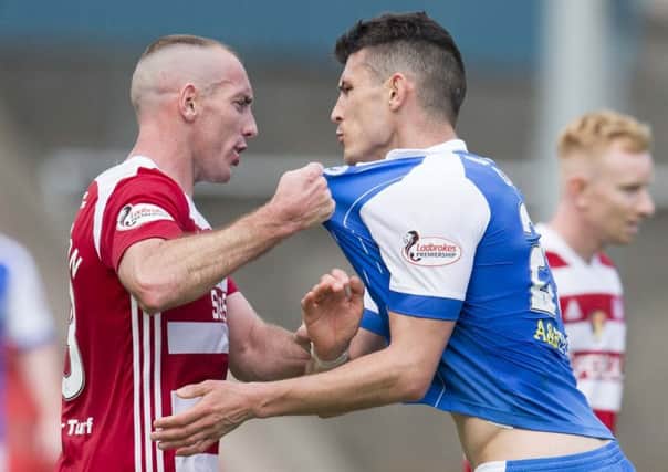 Darian MacKinnon gets involved with St Johnstone striker Graham Cummings. Picture: SNS Group