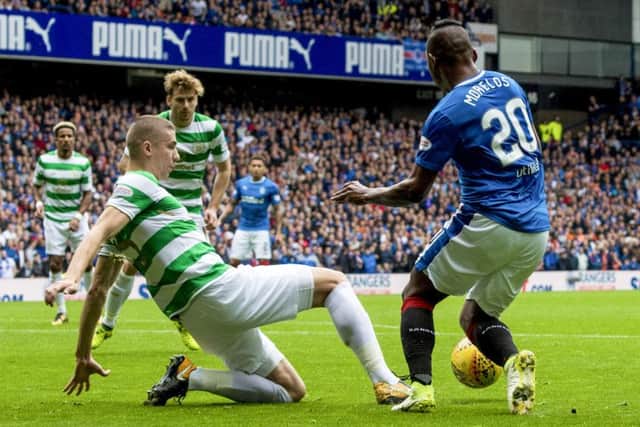 Alfredo Morelos goes down under the attentions of Jozo Simunovic. Picture: SNS