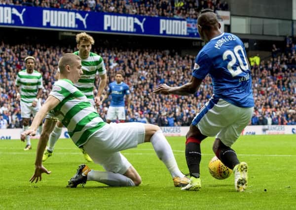 Alfredo Morelos goes down under the attentions of Jozo Simunovic. Picture: SNS