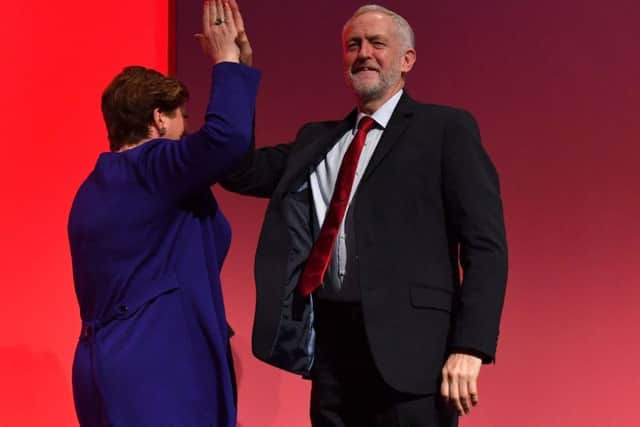 Jeremy Corbyn high-fives shadow foreign Secretary Emily Thornberry after her speech. Picture: Getty