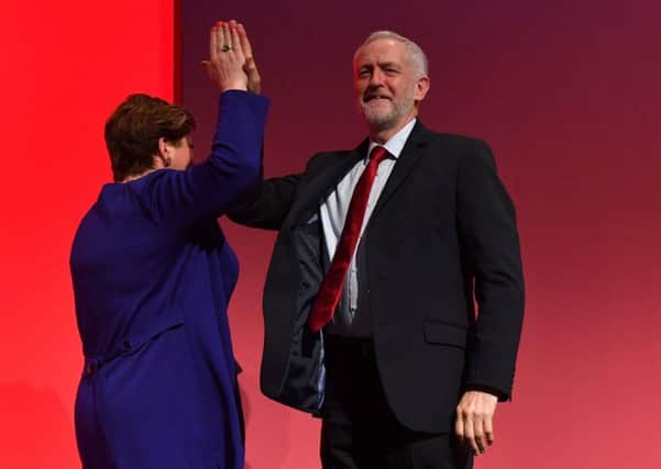 Jeremy Corbyn high-fives shadow foreign Secretary Emily Thornberry. Picture: Getty