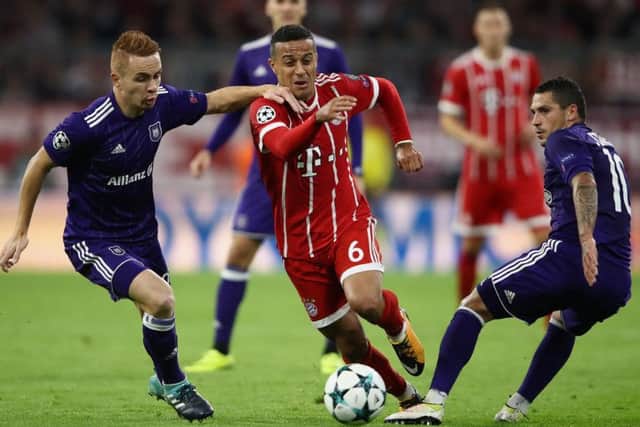 Adrien Trebel, left, and Nicolae Stanciu tussle with Thiago in the Champions League match between Bayern Munich and Anderlecht. Picture: Getty Images
